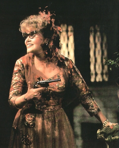 Mrs. Peacock (Eileen Brennan), holding a pistol.